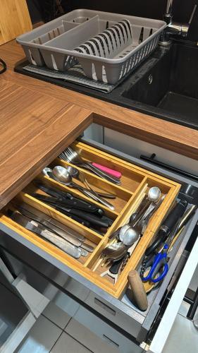a drawer in a kitchen with cooking utensils at DaxLodge T3 cosy in Dax