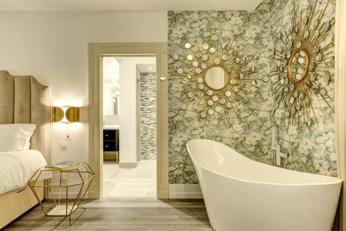 une salle de bain avec baignoire et une chambre avec un lit dans l'établissement Penthouse Le Lustre, à Chamonix-Mont-Blanc