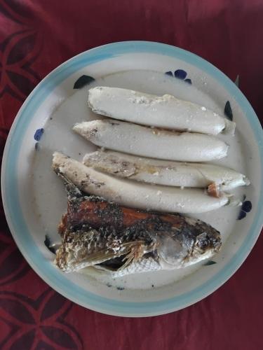 a plate of food with fish on a table at Save's Homestay in Nadi