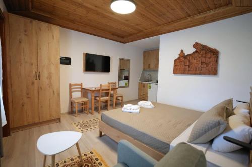 a living room with a bed and a table at Emblematic House Apartment 4 in Gjirokastër