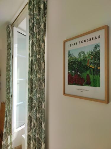 a picture hanging on a wall next to a window at Ô Bulles de Loire, Châteauneuf-sur-Loire in Châteauneuf-sur-Loire