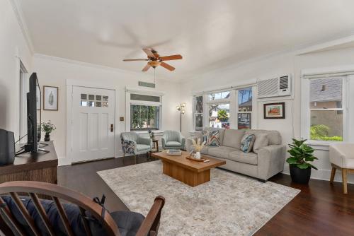 a living room with a couch and a ceiling fan at Timeless Charm by the Coast, Vintage Beach Bungalow in Long Beach