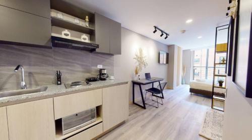 Una cocina con un fregadero y una mesa en una habitación. en SecreT Top 85, en Bogotá