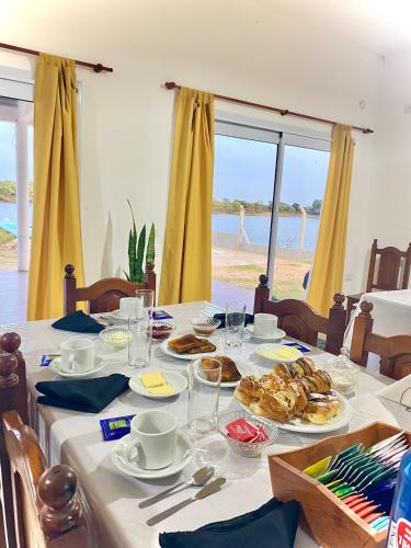 a table with food on it with a view of the beach at Esquina Lodge in Esquina