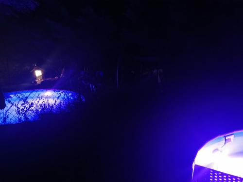 a dark room with a blue light in the dark at Tamerici House in Montecastrilli