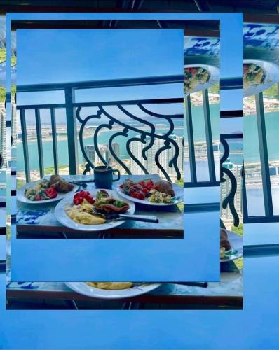 a table with three plates of food on it at Seaview condo near airport and Disney Land in Hong Kong