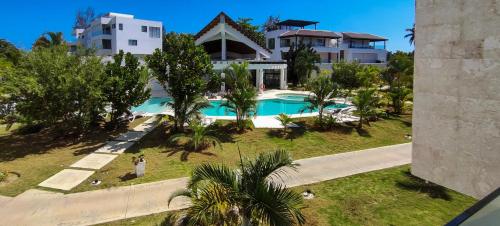 an aerial view of a house and a swimming pool at AMAR'E beach front apartment overlooking pool in Las Terrenas