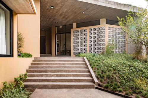 a set of stairs leading to a house at Spacious Apartment with Balcony in El Zonte