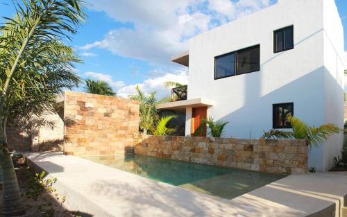 a house with a swimming pool in front of a house at Casa Dzunun in Santa Clara