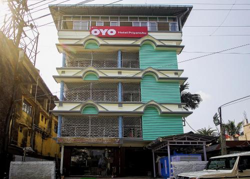 a tall building with a vox sign on it at Super Capital O Priyanshu in Siliguri