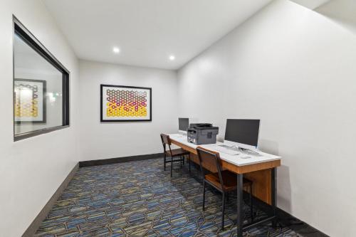 an office with a desk with a computer and chairs at Holiday Inn Express & Suites Mountain View Silicon Valley by IHG in Mountain View