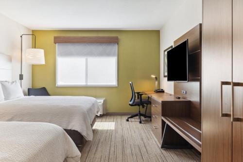 a hotel room with two beds and a flat screen tv at Holiday Inn Express & Suites Mountain View Silicon Valley by IHG in Mountain View