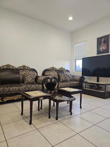 a living room with a couch and a tv at genie palace at statefarm stadium in Phoenix