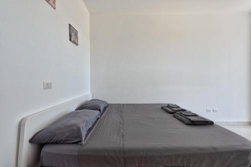 a bed in a white room with a mattress at Magnolie A37, Vista & comfort vicino al mare in Eraclea Mare