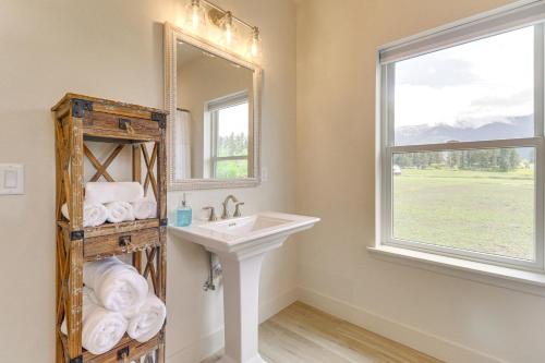 a bathroom with a sink and a mirror at Home 21 Mi to Glacier Natl Park Boat, Fish, Hike in Columbia Falls