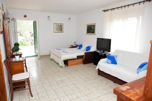 a living room with two beds and a couch at Apartments by the sea Promajna, Makarska - 2588 in Promajna