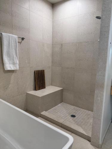 a bathroom with a shower with a tub and a toilet at Unicorn Zebra in Tucson