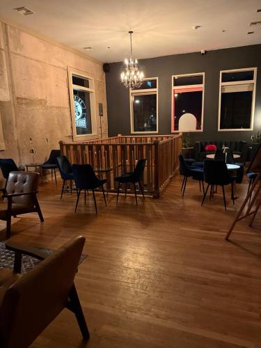 a restaurant with chairs and tables and a chandelier at Unicorn Zebra in Tucson