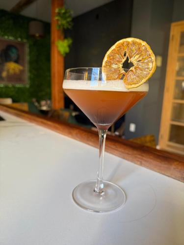 a drink with an orange slice in a glass at Unicorn Zebra in Tucson