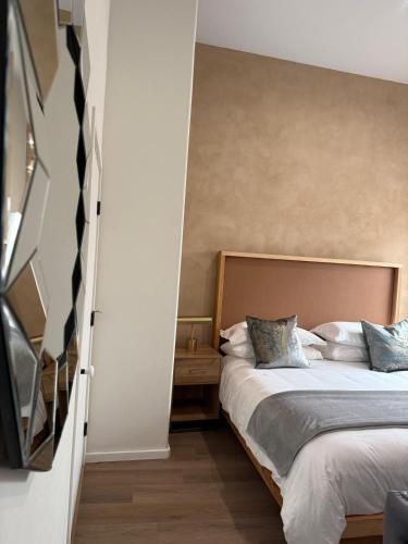 a bedroom with a large bed with blue pillows at Unicorn Zebra in Tucson