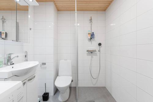 a bathroom with a shower and a toilet and a sink at Come in! "Värjäri" Stunning studio in newly built building in Pyynikki area! in Tampere