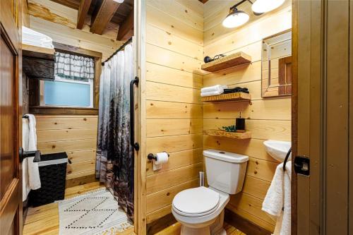 a wooden bathroom with a toilet and a sink at The River Shack - kayaks, fishing, quiet, family in Delta