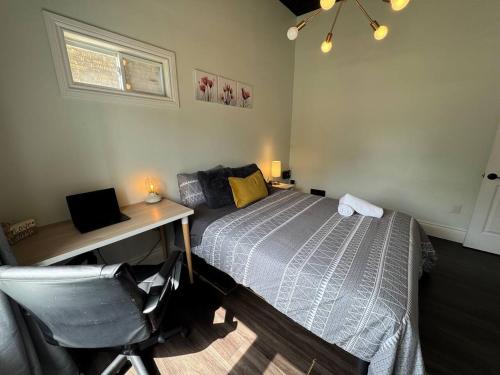 a bedroom with a bed and a desk and a desk at The Urban Nest - Windsor in Windsor