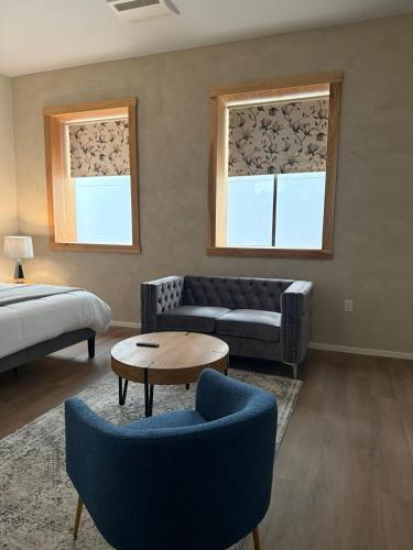 a living room with a couch and two windows at Unicorn Zebra in Tucson