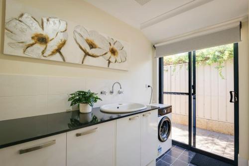 a bathroom with a sink and a washing machine at The Monclair Retreat - Pet Friendly Dunsborough in Dunsborough