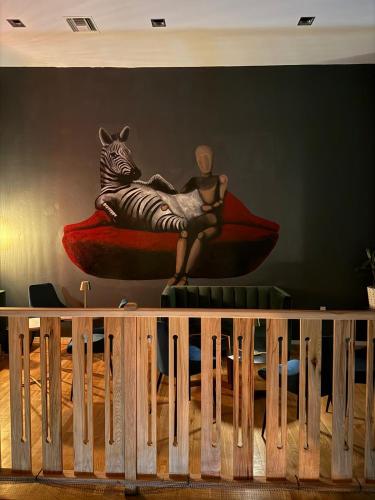 a mural of a man sitting on a zebra on a wall at Unicorn Zebra in Tucson