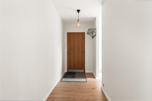 a hallway with a door and a rug at Perfect spacious 2-bedroom apartment near Sky Lagoon in Reykjavík