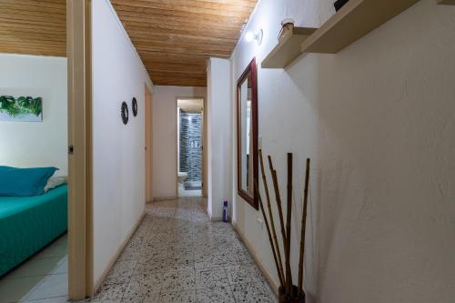 a hallway of a house with a bed and a room with a hallway at apartamento grande, hermoso, acogedor y privado in Medellín