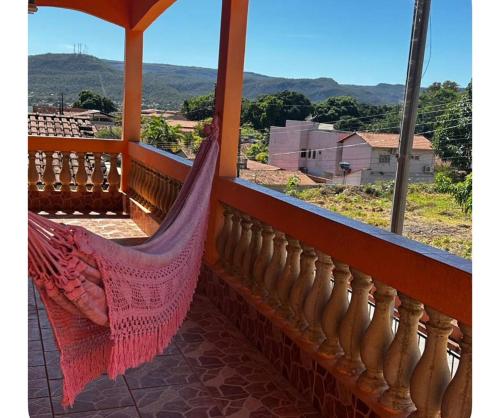 a hammock on a balcony with a view at Residencial Divina in Pirenópolis