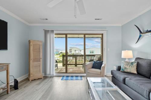 a living room with a couch and a glass table at Barefoot Ventures townhouse in Atlantic Beach