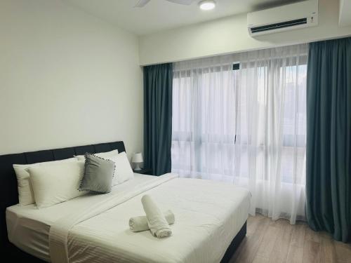 a bedroom with a bed with two stuffed animals on it at My Service Suites Agile KL in Kuala Lumpur