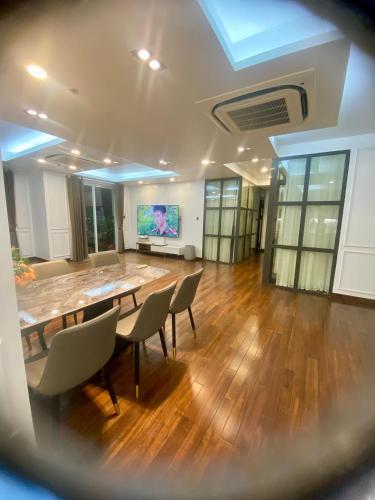 a large room with a table and chairs and a screen at SHP Plaza Khanh Phong Homestay in Hai Phong