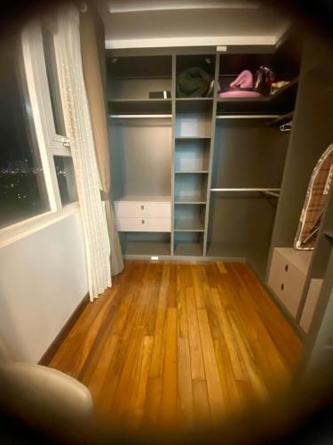 a room with a closet with wooden floors and a window at SHP Plaza Khanh Phong Homestay in Hai Phong