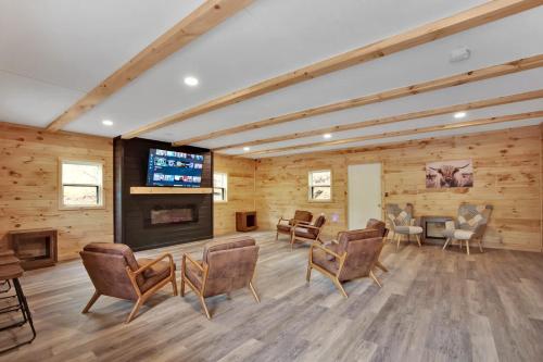 a large room with chairs and a flat screen tv at Water and Electric 30 Amp Pull through in Gaines