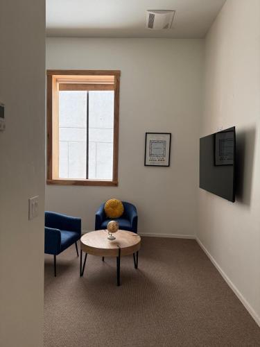a room with a table and two chairs and a window at Unicorn Zebra in Tucson