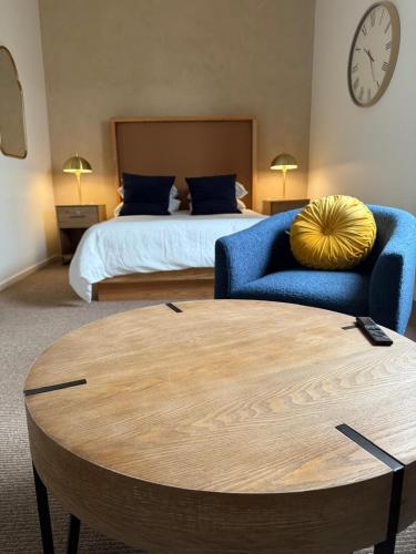 a bedroom with a bed and a blue couch and a table at Unicorn Zebra in Tucson