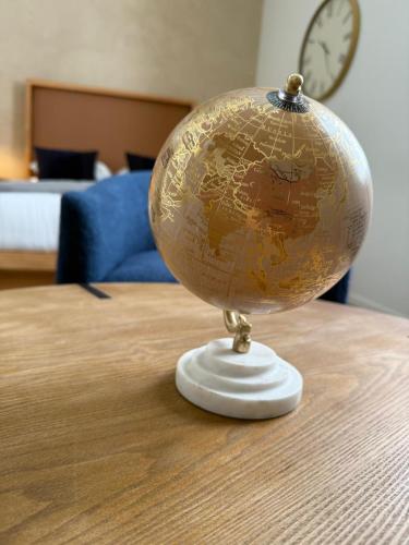 a globe on top of a table with a clock at Unicorn Zebra in Tucson
