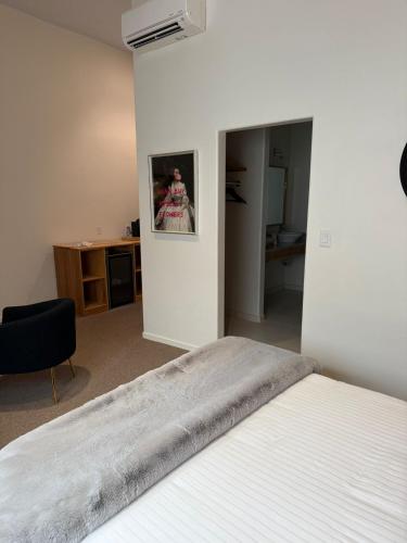 a bedroom with a bed with a picture on the wall at Unicorn Zebra in Tucson