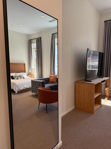 a mirror in a hotel room with a bedroom at Unicorn Zebra in Tucson