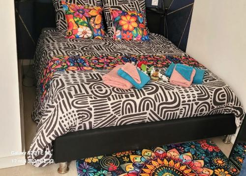 two beds with towels and pillows on them at Les Volets Bleus - Au Calme avec petit Jardin et Patio - 3 appartements in Bourges