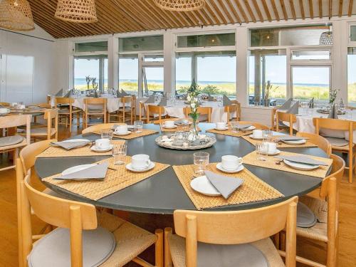 a dining room with a large table and chairs at 6 person holiday home on a holiday park in Sæby in Sæby