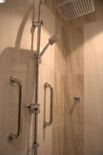 a shower in a bathroom with a glass shower stall at جولدن هافن Golden Haven in Ahad Rafidah