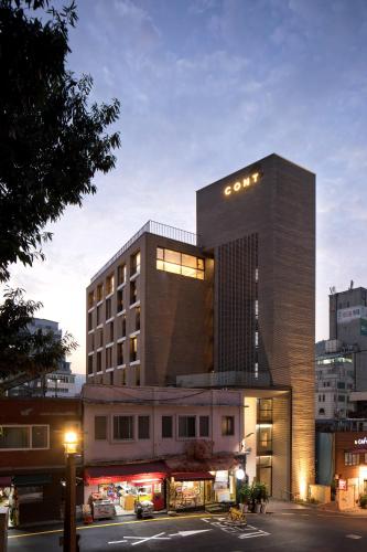 a building with a sign on top of it at Cont Hotel in Busan