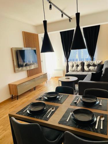 a living room with a table and a couch at Belle Vue Apartmani in Zlatibor