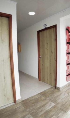 an empty room with a door and a wooden floor at sea crab in San Andrés