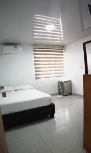a white room with a bed and a window at sea crab in San Andrés